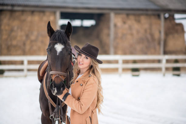istock Woman enjoying winter breaks with her horse 641154580