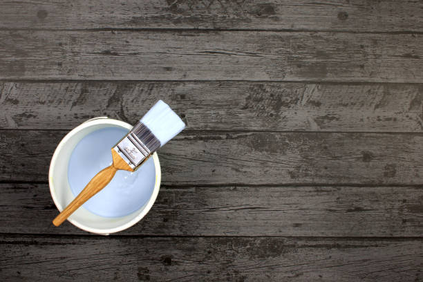 istock Paintbrush on a pot of light blue paint 641154640