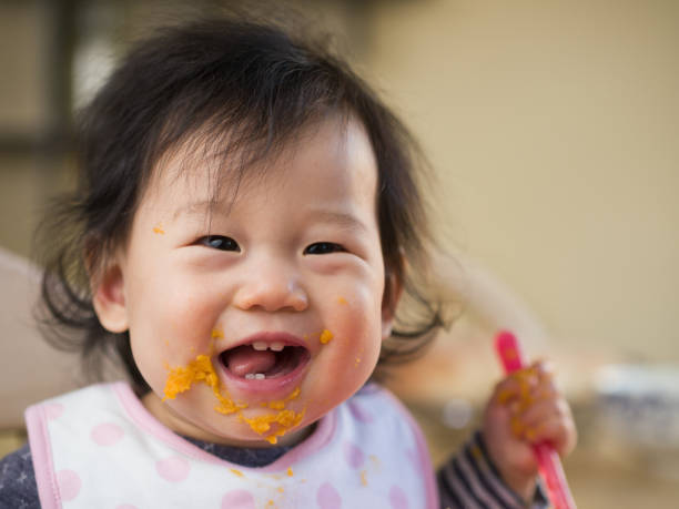 istock eating mess baby girl 641154772