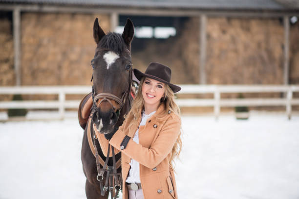istock Woman enjoying winter breaks with her horse 641155112
