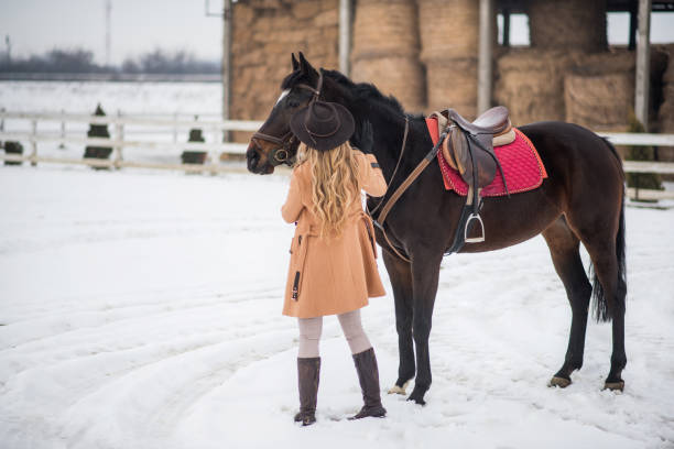 istock Woman enjoying winter breaks with her horse 641155148