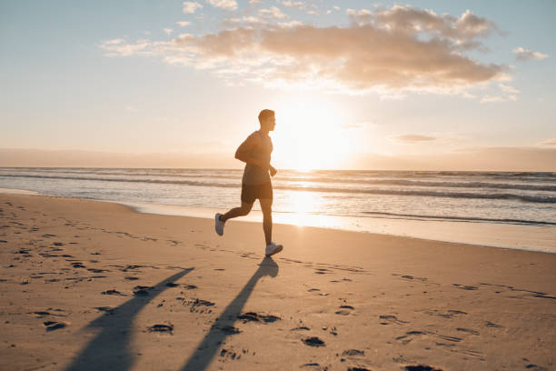 istock Runner running in morning along the beach 641155184