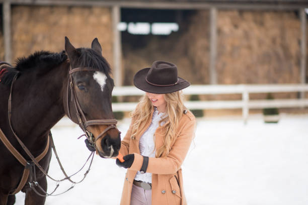 istock Woman enjoying winter breaks with her horse 641155394
