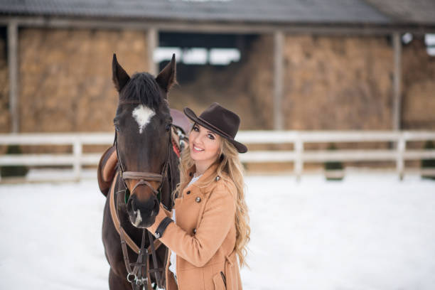 istock Woman enjoying winter breaks with her horse 641155452