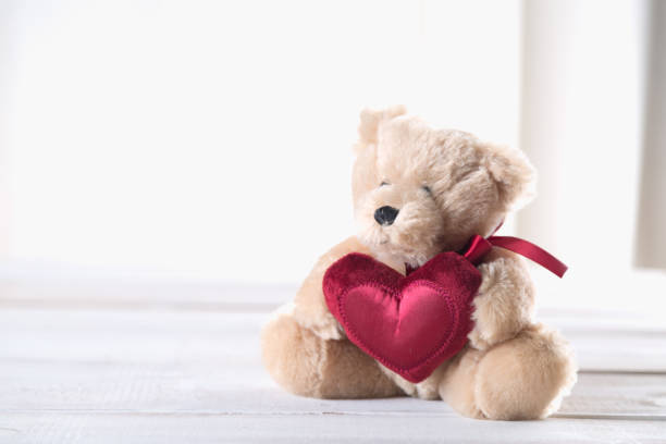 istock Cute valentines bear on bright wooden background 641157022