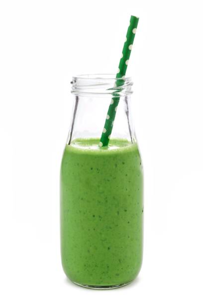 istock Green smoothie in a milk bottle isolated on white 641160758