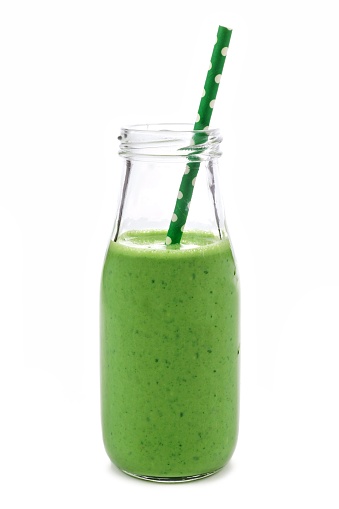 Green smoothie in a milk bottle isolated on a white background