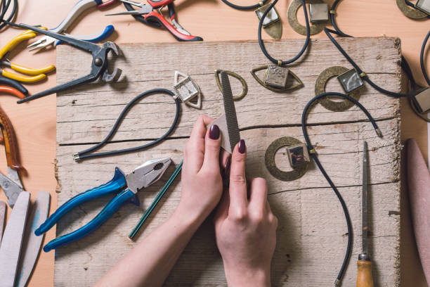istock Female designer making jewelry 641163260