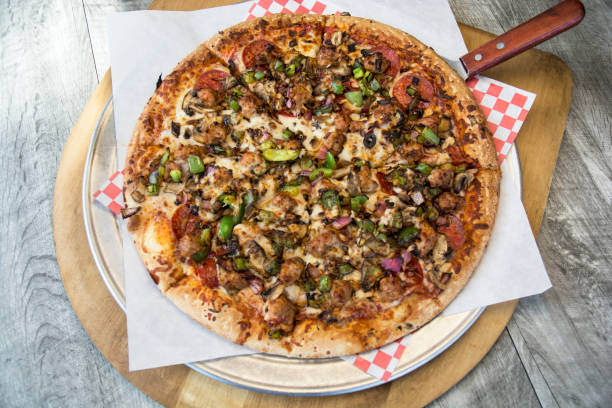 istock Gourmet Hero Pizza On Wood Platter 641164108