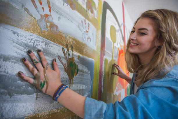 istock Girl painting with hands 641164432
