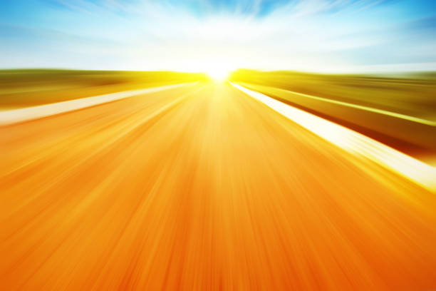 Country asphalt road in motion blur at sunset.