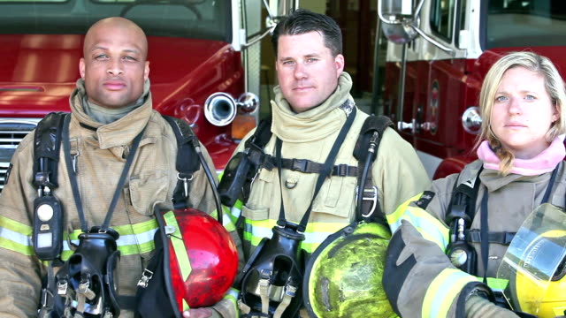 Group of three multi-ethnic firefighters at the station