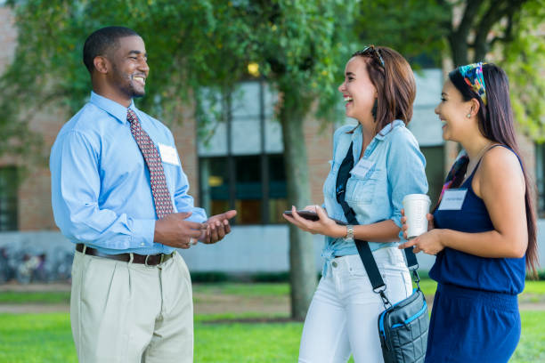 istock Female college students talk with campus tour guide 641168492