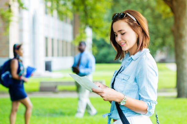 istock Cheerful college student looks at class schedule on campus 641168540