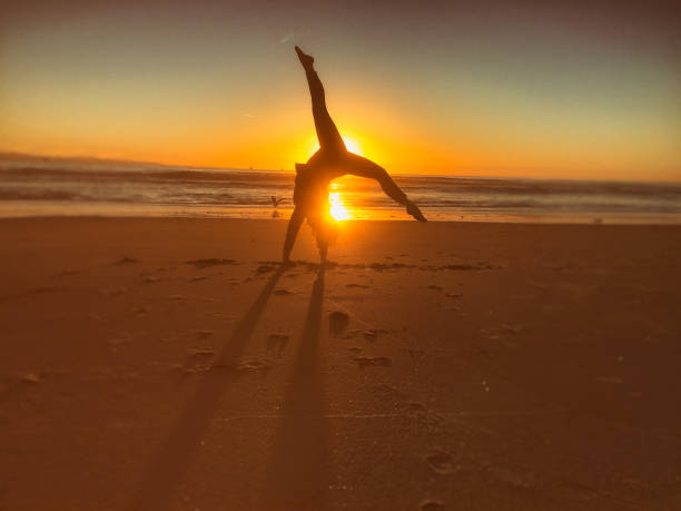 istock Woman doing yoga at sunset 641170516
