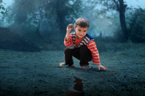Cute innocent little boy sitting targeting his aim during playing games.
