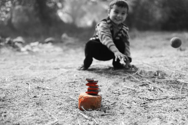 Cute innocent little boy sitting targeting his aim during playing games.