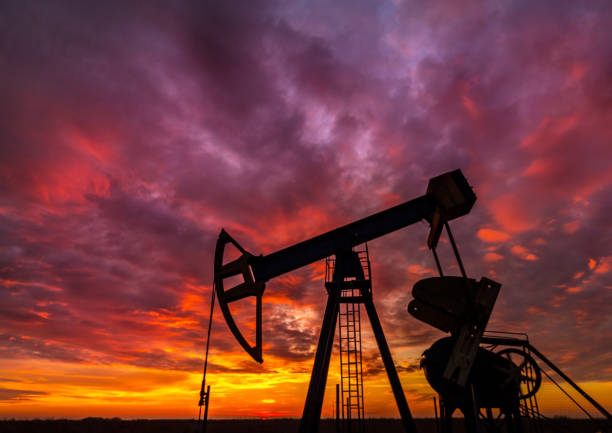 istock Operating oil and gas well, profiled on dramatic sunset 641174536