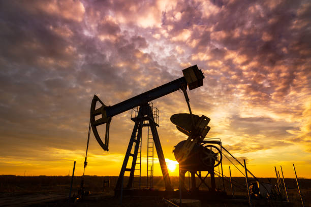 istock Operating oil and gas well, profiled on dramatic sunset 641174808