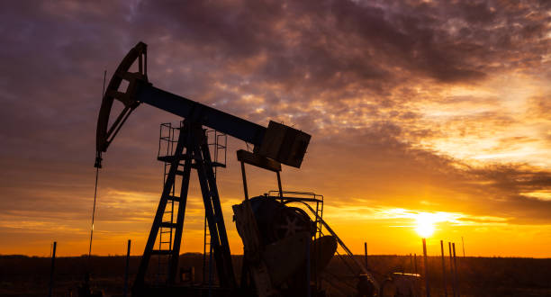 istock Operating oil and gas well, profiled on dramatic sunset 641174828