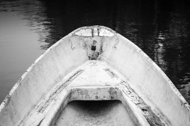 istock Empty bow of old white grungy rowboat 641176130