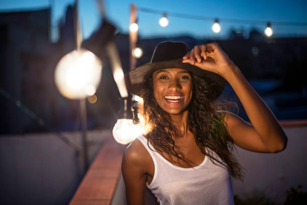 istock Cheerful woman standing on illuminated terrace 641176610