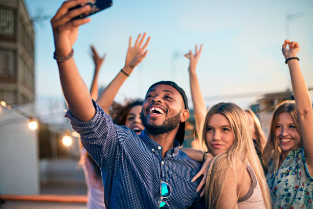 istock Friends taking selfie during terrace party 641176628