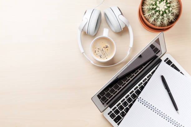 istock Office desk with laptop, coffee and headphones 641178428