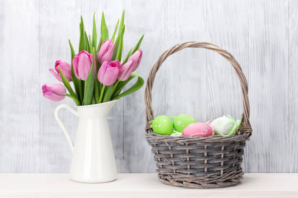 istock Easter eggs and pink tulips bouquet 641179574