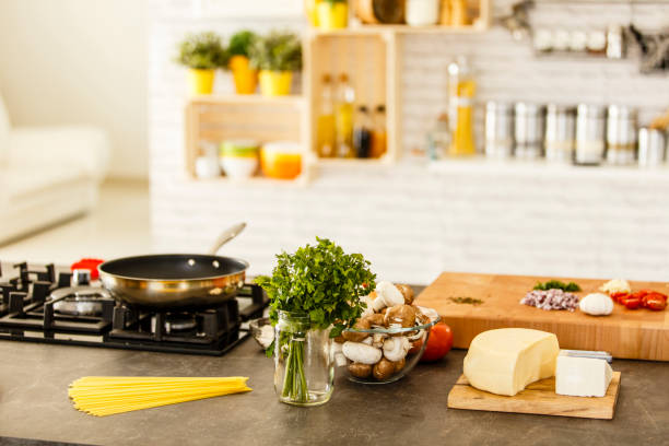 istock Frying pan on stove, food ingredients on kitchen counter 641182900