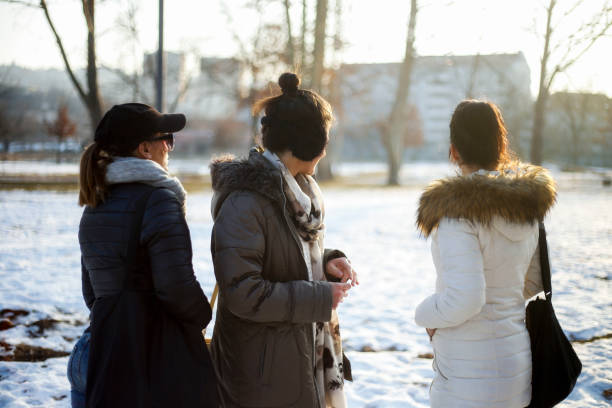 istock Three young women in park enjoy in sunny day 641183832