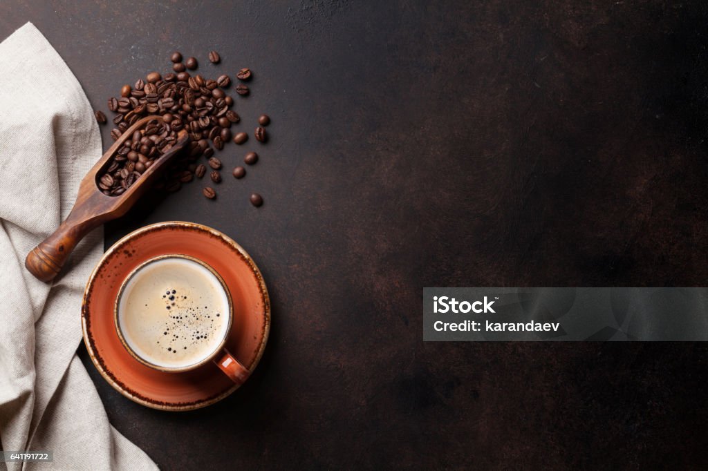 Coffee cup on old kitchen table Coffee cup and beans on old kitchen table. Top view with copyspace for your text Kitchen Stock Photo