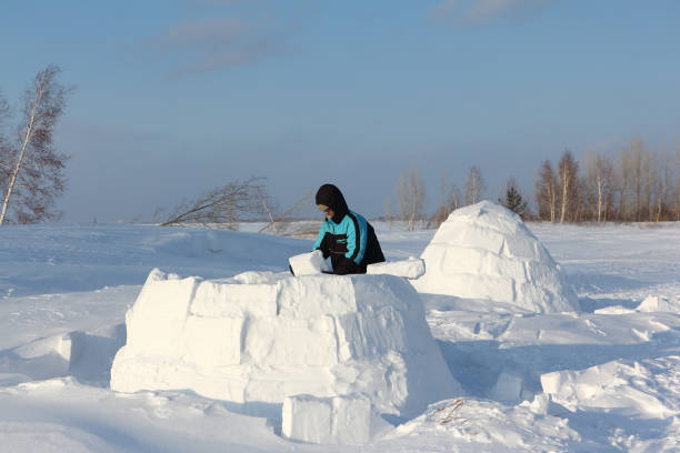 istock Man building an igloo of snow blocks 641191760