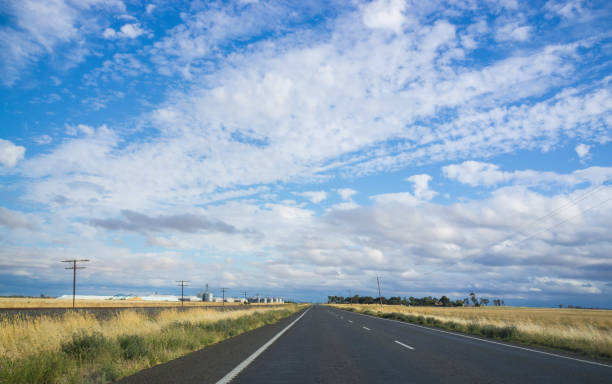 istock Highway among yellow fields next to railway track. Rural landscape. 641193084