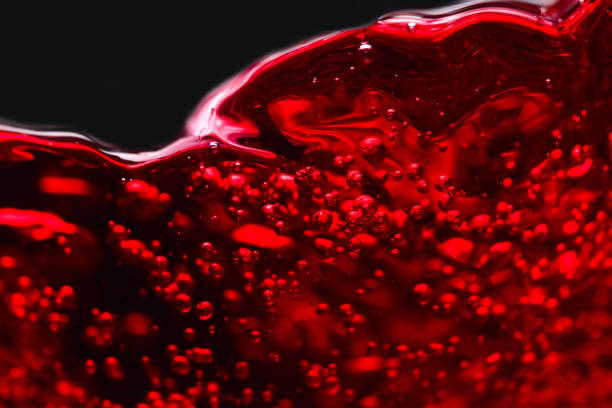istock Abstract splashes of red wine on a black background 641193650