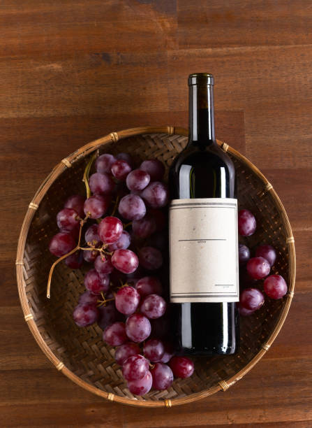 istock bottle of red wine with grape 641193784