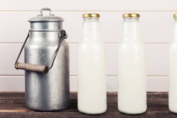 istock old milk can and bottles on wooden table 641194466