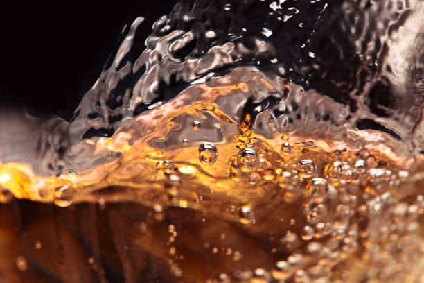 istock Abstract splashes of white wine on a black background 641194790