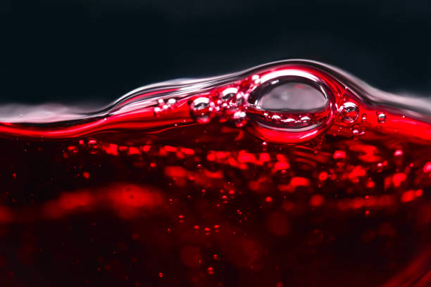 istock Abstract splashes of red wine on a black background 641194812