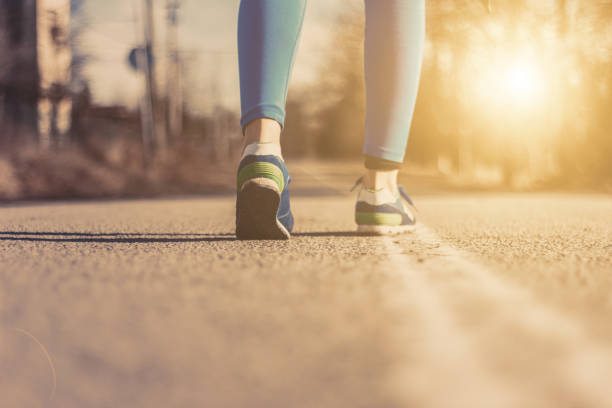 istock Runner feet running on road closeup on shoe 641194936