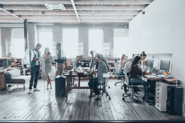 Team at work. Group of young business people in smart casual wear working together in creative office office work stock pictures, royalty-free photos & images