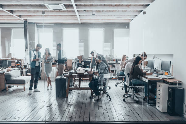 Team at work. Group of young business people in smart casual wear working together in creative office busy office stock pictures, royalty-free photos & images