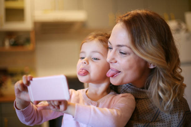 Mother with daughter making funny face. stock photo