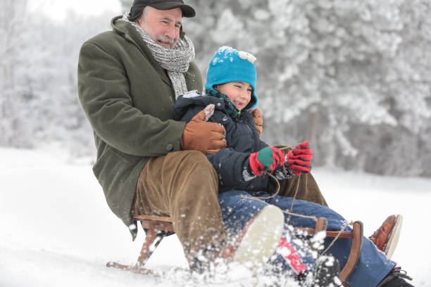 istock Grandfather with grandson sledding 641199818