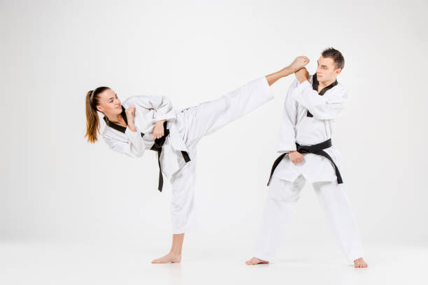 istock The karate girl and boy with black belts 641200252