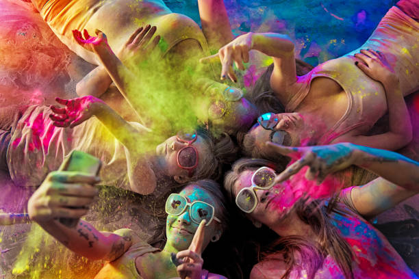 Group of Young Women covered with holi powder Group of young women covered with holi powder hippie photos stock pictures, royalty-free photos & images