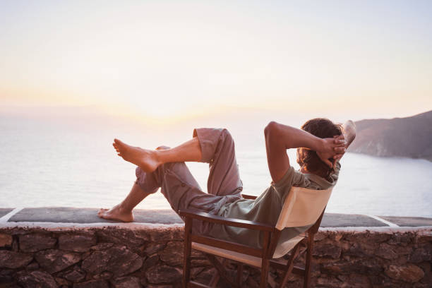 istock Man on vacations relaxing and looking on sunset 641202572