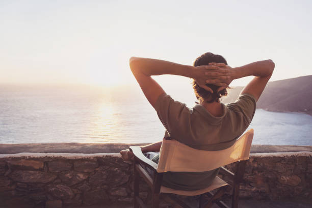 istock Man on vacations relaxing and looking on sunset 641202574