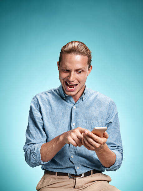 istock The young surprised caucasian man on blue background 641203608
