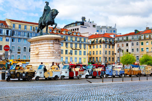 Lisbon, Portugal - 04 17 2015: many tuk-tuks wating for tourists on John I of Portugal Place in Lisbon, Portugal stock photo